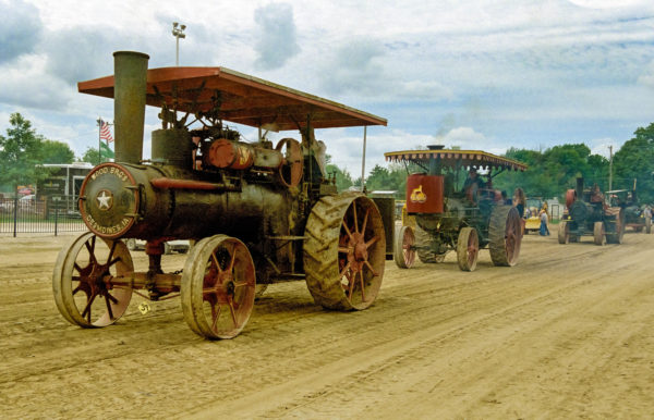 A cavalcade of power, like the 1913 Wood Brothers steam engine tractors operated by Bob and Melinda Stevens in this picture, is always on display at the Midwest Old Threshers Reunion. Photo courtesy of Midwest Old Threshers Reunion